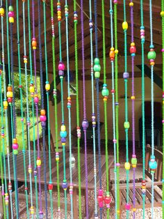 colorful beads hanging from the roof of a tent