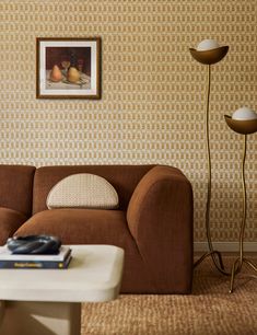 a living room with a couch, coffee table and lamp