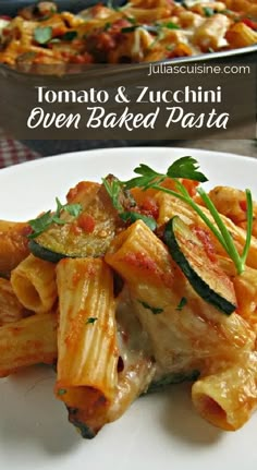 pasta with tomato sauce and zucchini on a white plate next to a casserole dish