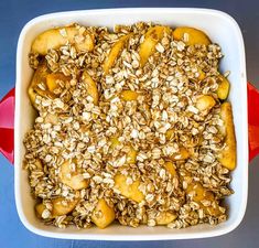 a casserole dish filled with oats and bananas on top of a blue table