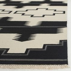 a black and white rug with fringes on it