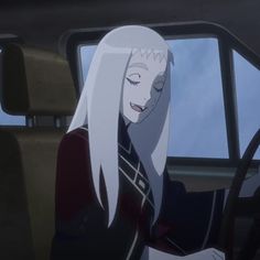 a woman with long white hair sitting in a car