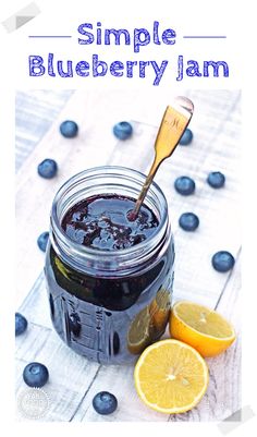 a jar filled with blueberry jam next to sliced lemons