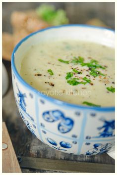 a blue and white bowl filled with soup