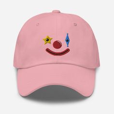 Embroidered clown dad hat!  * 100% chino cotton twill * Green Camo color is 35% chino cotton twill, 65% polyester * Unstructured, 6-panel, low-profile * 6 embroidered eyelets * 3 ⅛" (7.6 cm) crown * Adjustable strap with antique buckle * Blank product sourced from Vietnam or Bangladesh This product is made especially for you as soon as you place an order, which is why it takes us a bit longer to deliver it to you. Making products on demand instead of in bulk helps reduce overproduction, so thank Fun Cotton Hat With Curved Bill, Playful Cotton Trucker Hat In Baseball Cap Style, Fun Cotton Trucker Hat With Curved Brim, Fun Adjustable Cotton Dad Hat, Fun Cotton Snapback Baseball Cap, Fun Cotton Hats For Streetwear, Fun Cotton Baseball Cap, Fun Dad Hat For Streetwear, Fun Cotton Trucker Hat