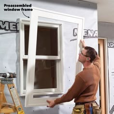 a man working on a window in the process of remodeling