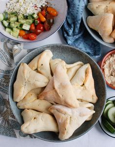 some food that is in a bowl on a table with other dishes and bowls around it