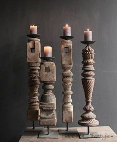 three wooden candlesticks sitting next to each other