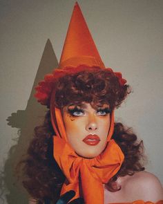 a woman wearing an orange hat and scarf