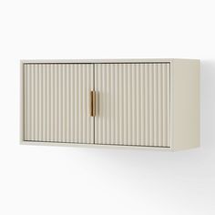 a white wall mounted cabinet with two doors and a gold handle on the bottom shelf