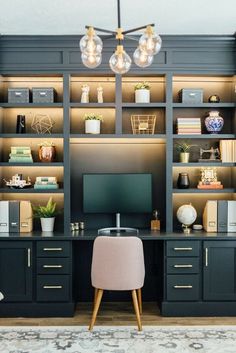 a home office with built - in shelving and desk