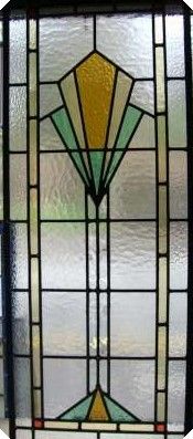 an old stained glass window with yellow and green designs on the bottom half of it