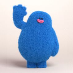 a blue stuffed animal with one arm raised