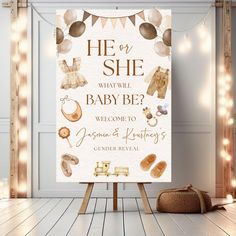 a baby shower sign is displayed in front of a white wall with lights on it