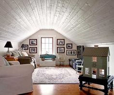 a living room filled with furniture and pictures on the wall