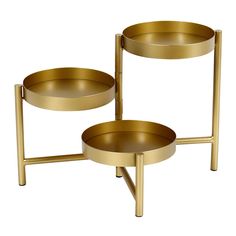 two brass trays with handles on each side, one holding a bowl and the other holding a plate