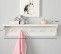 a white shelf with two hooks and a stuffed animal