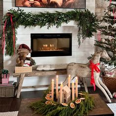 a living room decorated for christmas with candles