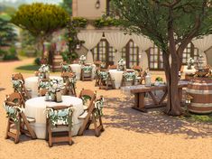 a table and chairs are set up in the middle of a courtyard with wine barrels