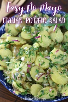 easy no - mayo italian potato salad in a blue bowl on a wooden table with text overlay