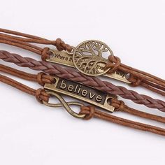 three leather bracelets with metal charms and words that say believe, where are they?