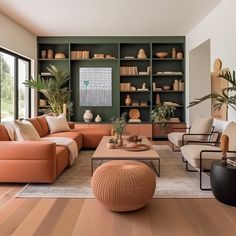 a living room filled with lots of furniture next to a large open book shelf covered in books