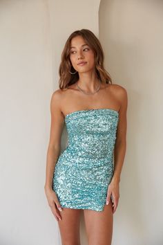 Make the whole place shimmer in the Hailey Strapless Sequin Bodycon Mini Dress! This mini dress features all over sequins, a mini length with a flirty leg slit, and a folded over, straight across neckline. Available in a gorgeous silver multi and aqua blue. Step into the Chinese Laundry Avianna Heels for a party look! Details 97% Polyester, 3% Spandex Lining: 95%, 5% Spandex Back zip closure Inner silicone grips Stretchy fit Hand wash cold / Hang dry Hoco Dress Inspo Short Blue, Sequin Homecoming Dress Mini, Rio Hoco Dresses, Mermaid Hoco Dress, Multi Colored Hoco Dress, Short Tight Hoco Dresses, Aqua Hoco Dress, Homecoming 2024 Dress, Sweetheart Hoco Dress