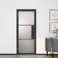 an empty room with white walls and black glass doors on the door, next to a sideboard