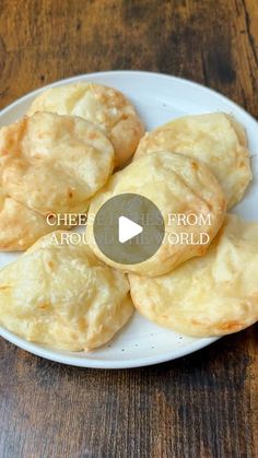 some food is on a white plate on a wooden table with the words cheesy bread from around the world