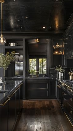 an elegant kitchen with black cabinets and gold trim on the counter tops is pictured in this image