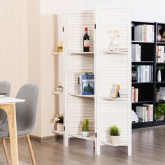 a dining room table and chairs with bookshelves in the background