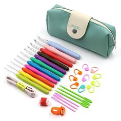 a green case filled with lots of different colored pens and markers on top of a white surface