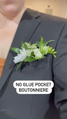 a woman wearing a black suit and flower boutonniere with no glue pocket