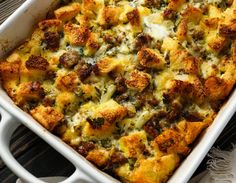 a casserole dish with meat and cheese in it sitting on a table next to a napkin