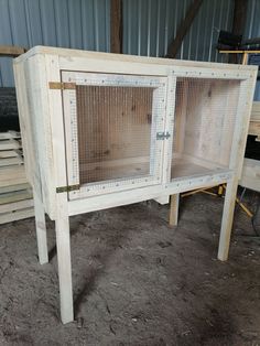 a white wooden cabinet sitting inside of a building