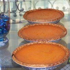 three pies sitting on top of a glass table