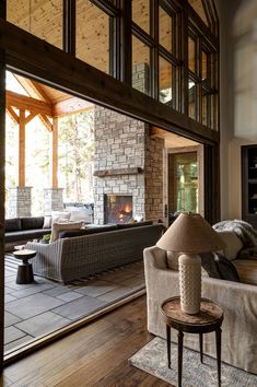 a living room filled with furniture and a fire place in the middle of a room