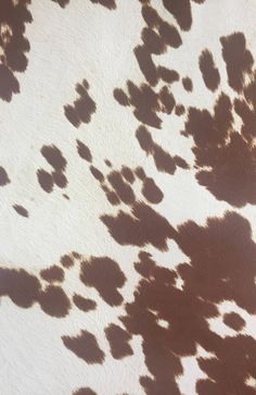 an animal print pattern is shown in brown and white colors, with the shadow of it's tail