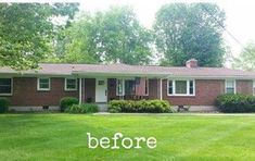 a red brick house sitting in the middle of a lush green yard with trees and bushes