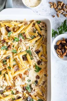 a casserole dish filled with pasta and mushrooms