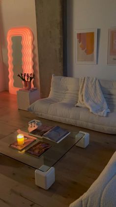 a living room filled with furniture and a lit candle on top of a coffee table