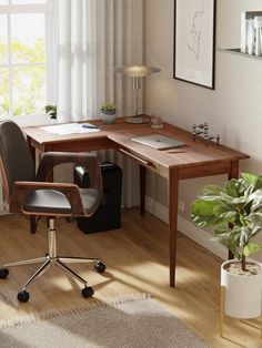 a corner desk with a laptop on it and a chair next to it in front of a window