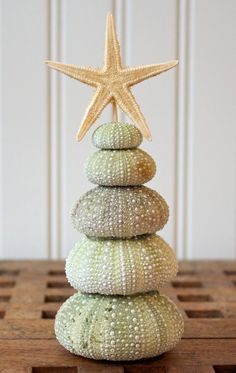 a stack of sea shells with a star on top