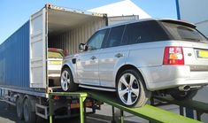 an suv is being loaded onto a flatbed truck