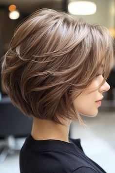 Save this pin for the best layered bob haircuts. Looking for a shorter style with personality? This cut offers exactly that. The short length keeps it fresh, while feathered layers add a touch of softness and volume. Stacked Haircuts With Bangs, Ladies Medium Length Hairstyles, Shorter Bob Hairstyles, Medium Length Angled Bob Haircut, Center Part Short Hair, Short Womens Haircuts With Bangs, Layered Bob Side Part, Bob Short Layers, Medium Length Layered Bob Hairstyles