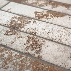 brown and white tiles with dirt on them