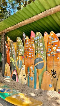 many surfboards are lined up under a roof