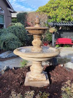 a stone fountain in the middle of a garden