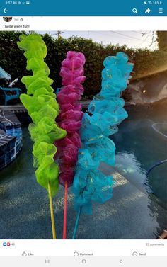 three different colored lollipops sitting next to each other on top of a table