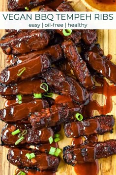 bbq ribs on a cutting board with sauce and green onions